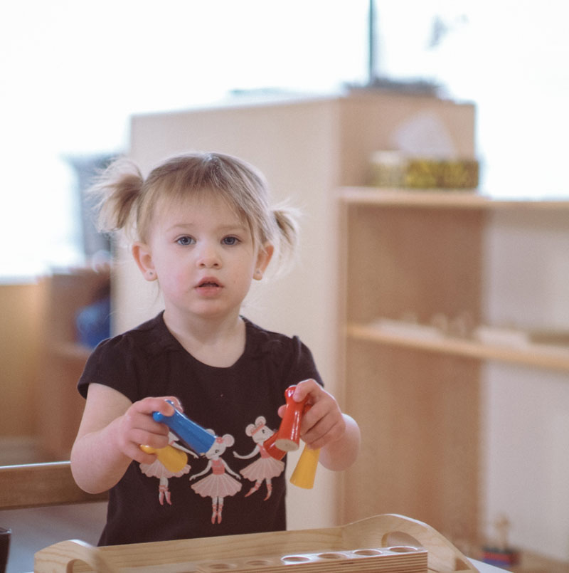 Child playing with Montessori tools
